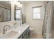 Bathroom featuring dual sinks, framed mirrors, and a shower with a curtain at 1537 Wheaton Nw Way, Concord, NC 28027