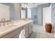 Bathroom featuring dual sinks, white countertops, and decorative floor tiles at 1537 Wheaton Nw Way, Concord, NC 28027
