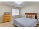 Cozy bedroom with a window, light blue walls, and carpet floors at 1537 Wheaton Nw Way, Concord, NC 28027