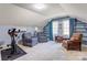 Bonus room with two chairs, wall shelving, and an exercise bike at 1537 Wheaton Nw Way, Concord, NC 28027