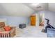 Spacious bonus room with an armoire, gray ottoman, and exercise bike for a flexible living space at 1537 Wheaton Nw Way, Concord, NC 28027
