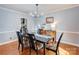 Formal dining room featuring hardwood floors, modern chandelier, and ample natural light at 1537 Wheaton Nw Way, Concord, NC 28027