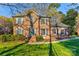 Beautiful brick two-story home with well-maintained lawn, mature landscaping and charming blue shutters at 1537 Wheaton Nw Way, Concord, NC 28027
