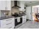 Modern kitchen featuring stainless steel appliances, gray backsplash, and white cabinets at 1537 Wheaton Nw Way, Concord, NC 28027