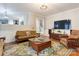 Open living room with hardwood floors, large windows, and seamless flow to the kitchen and staircase at 1537 Wheaton Nw Way, Concord, NC 28027