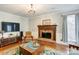 Relaxing living room featuring a brick fireplace, hardwood floors, and neutral tones for a cozy ambiance at 1537 Wheaton Nw Way, Concord, NC 28027