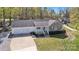 Spacious single-story home featuring brick accents, two car garage and a wide driveway in a wooded area at 1584 Beverly Ln, Lincolnton, NC 28092