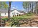 Spacious backyard featuring a well-maintained lawn, a wooden deck, and mature trees at 1584 Beverly Ln, Lincolnton, NC 28092