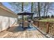 Wooden deck with outdoor seating, table, a black umbrella, and a backyard playground at 1584 Beverly Ln, Lincolnton, NC 28092