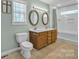 This bathroom boasts a double vanity, a linen closet, and natural light at 1584 Beverly Ln, Lincolnton, NC 28092