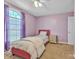 Bedroom with an inviting bed, large window, and charming decor, creating a relaxing space at 1584 Beverly Ln, Lincolnton, NC 28092