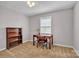 This bedroom features neutral walls, an organized bookshelf, and a desk by the window at 1584 Beverly Ln, Lincolnton, NC 28092