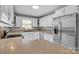 Bright kitchen with white cabinets, stainless steel appliances, and ample countertop space at 1584 Beverly Ln, Lincolnton, NC 28092