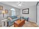 Comfortable living room features a blue sofa, wooden chest, and decorative pillows with lots of natural light at 1584 Beverly Ln, Lincolnton, NC 28092