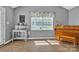 Sunlit living room features light hardwood floors, a window, and gray walls perfect for relaxing at 1584 Beverly Ln, Lincolnton, NC 28092