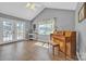 Bright sunlit living room with hardwood floors, a piano, and double doors to the backyard at 1584 Beverly Ln, Lincolnton, NC 28092