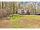 Exterior view of a cozy outbuilding nestled in a wooded setting with a well-manicured lawn at 1584 Beverly Ln, Lincolnton, NC 28092
