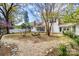Scenic backyard with a stone bench, lush landscaping, and a well-maintained lawn at 165 Mimosa Ter, Wadesboro, NC 28170