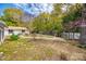 Secluded backyard with mature trees, a privacy fence, and pergola, providing a peaceful retreat at 165 Mimosa Ter, Wadesboro, NC 28170