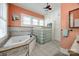 Bathroom featuring a jacuzzi tub, glass block privacy window, and white cabinets for storage at 165 Mimosa Ter, Wadesboro, NC 28170