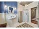 Bathroom featuring a sink, shower, and wainscoting with a decorative metal ceiling and an area rug at 165 Mimosa Ter, Wadesboro, NC 28170
