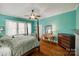 Bedroom with hardwood floors, a ceiling fan, light turquoise walls, and a four-poster bed at 165 Mimosa Ter, Wadesboro, NC 28170