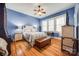 Cozy bedroom with hardwood floors, a ceiling fan, windows with blinds, and light blue painted walls at 165 Mimosa Ter, Wadesboro, NC 28170