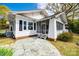 Back view of a charming home featuring a screened porch and stone patio at 165 Mimosa Ter, Wadesboro, NC 28170
