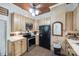 Charming kitchen with wood cabinets, stainless appliances, and exposed brick accents at 165 Mimosa Ter, Wadesboro, NC 28170