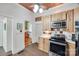 Efficient kitchen layout with stainless steel appliances, wooden cabinets, and access to other rooms at 165 Mimosa Ter, Wadesboro, NC 28170