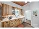 Bright kitchen showcasing wooden cabinets, a stainless steel dishwasher, and a garden window at 165 Mimosa Ter, Wadesboro, NC 28170