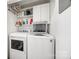 Functional laundry room with white washer and dryer, shelving, and storage cabinets at 165 Mimosa Ter, Wadesboro, NC 28170
