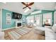 Bright living room with a cozy fireplace, skylight, wood-look flooring, and ample natural light at 165 Mimosa Ter, Wadesboro, NC 28170