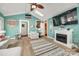 Inviting living room featuring a decorative fireplace, hardwood floors, and a connected room for easy access at 165 Mimosa Ter, Wadesboro, NC 28170