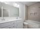 Bright bathroom with double sink vanity, large mirror, and shower/tub combo at 19751 Feriba Pl, Cornelius, NC 28031