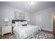 Bright bedroom featuring a comfortable bed with white linens, two side tables and decor at 19751 Feriba Pl, Cornelius, NC 28031