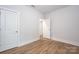Bedroom featuring wood-style flooring, neutral walls and two doors at 19751 Feriba Pl, Cornelius, NC 28031