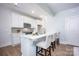 Gourmet kitchen with island seating, stainless appliances, and bright white cabinets at 19751 Feriba Pl, Cornelius, NC 28031