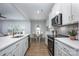 Open kitchen overlooking the dining and living area, featuring quartz counters at 19751 Feriba Pl, Cornelius, NC 28031
