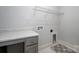 Bright laundry room with folding table, and metal rack at 19751 Feriba Pl, Cornelius, NC 28031