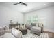 Inviting living room with modern furnishings, natural light, and sleek ceiling fan at 19751 Feriba Pl, Cornelius, NC 28031
