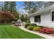 Serene backyard with a lush lawn, colorful landscaping, and an outdoor kitchen, creating an inviting outdoor oasis at 2015 Pellyn Wood Dr, Charlotte, NC 28226