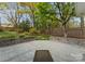 Backyard view featuring a brick wall, lawn, and patio offering a great space for outdoor activities and relaxation at 2015 Pellyn Wood Dr, Charlotte, NC 28226
