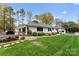 Backyard with lush lawn, custom pizza oven, and ample patio space for outdoor gatherings and relaxation at 2015 Pellyn Wood Dr, Charlotte, NC 28226