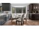 Cozy breakfast nook with gray cabinetry, banquette seating, and large bay window at 2015 Pellyn Wood Dr, Charlotte, NC 28226