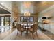 Charming dining room featuring a chandelier, textured wallpaper, and seating for six at 2015 Pellyn Wood Dr, Charlotte, NC 28226