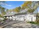 Beautiful white home with a large garage, mature landscaping, and a spacious driveway with plenty of parking at 2015 Pellyn Wood Dr, Charlotte, NC 28226
