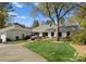Charming single-story home with a well-manicured lawn and mature trees at 2015 Pellyn Wood Dr, Charlotte, NC 28226