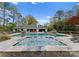Backyard swimming pool with a hot tub, featuring a spacious lounge area and outdoor seating at 2015 Pellyn Wood Dr, Charlotte, NC 28226