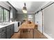Bright laundry room with gray cabinets, modern washer and dryer, and wooden table at 2015 Pellyn Wood Dr, Charlotte, NC 28226